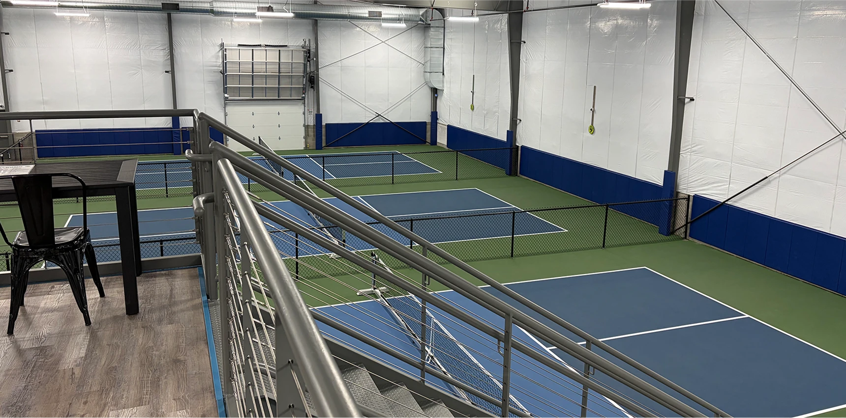 In A Pickle indoor pickleball courts viewed from the mezzanine